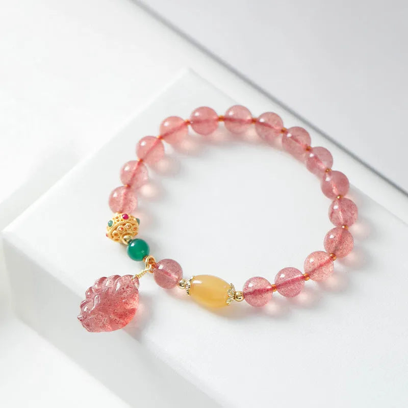 Women's Nine Tail Fox design bracelet with polished strawberry quartz crystal beads.