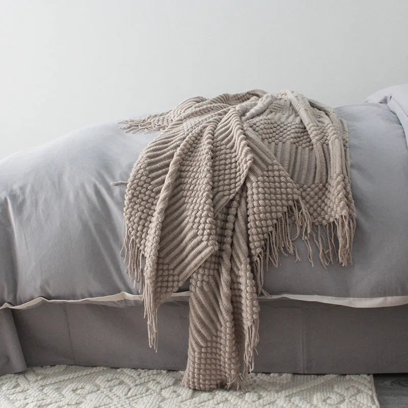 Small light grey polyester throw blanket folded, showing its rectangular 127cm by 170cm size.