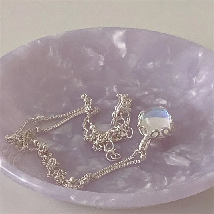 Silver geometric pendant on an adjustable curb chain necklace.