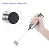 Silver handheld electric milk frother with double teat stainless steel whisk head on white background