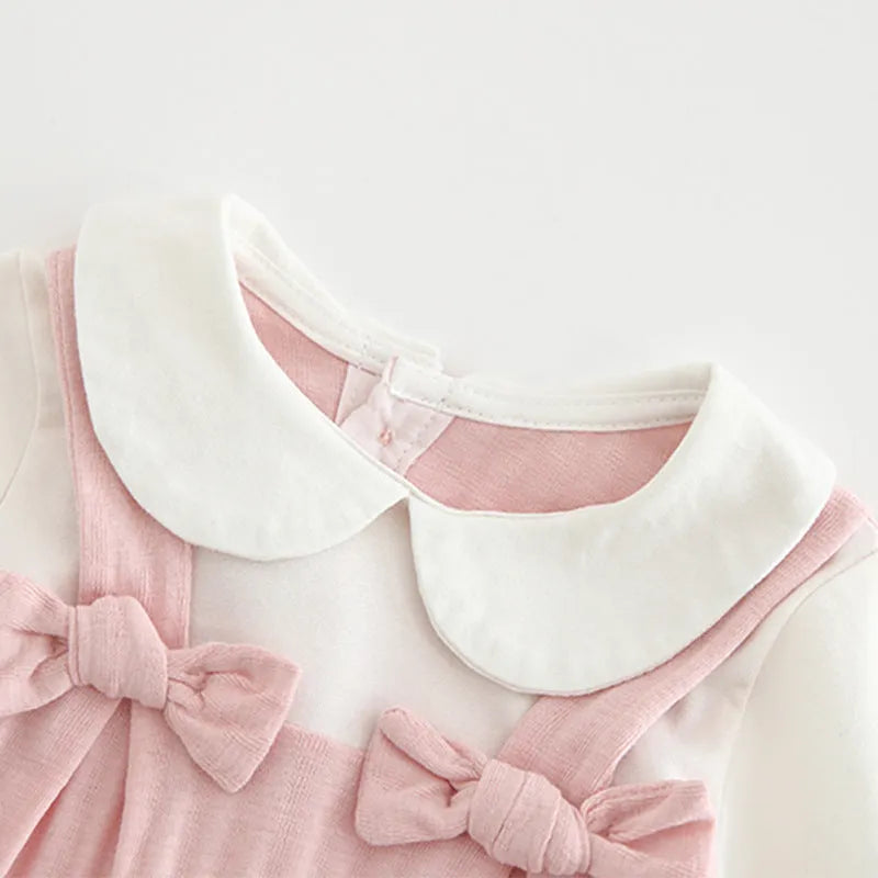 Pink long sleeve cotton baby jumpsuit with single-breasted front closure for a girl.