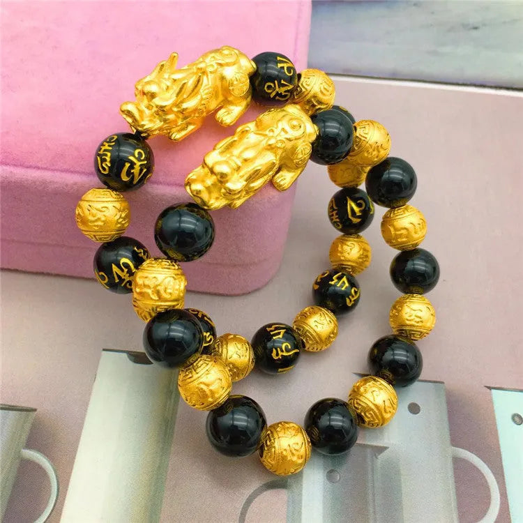 Vietnamese sand gold gold-plated brave bracelet with black beads on display
