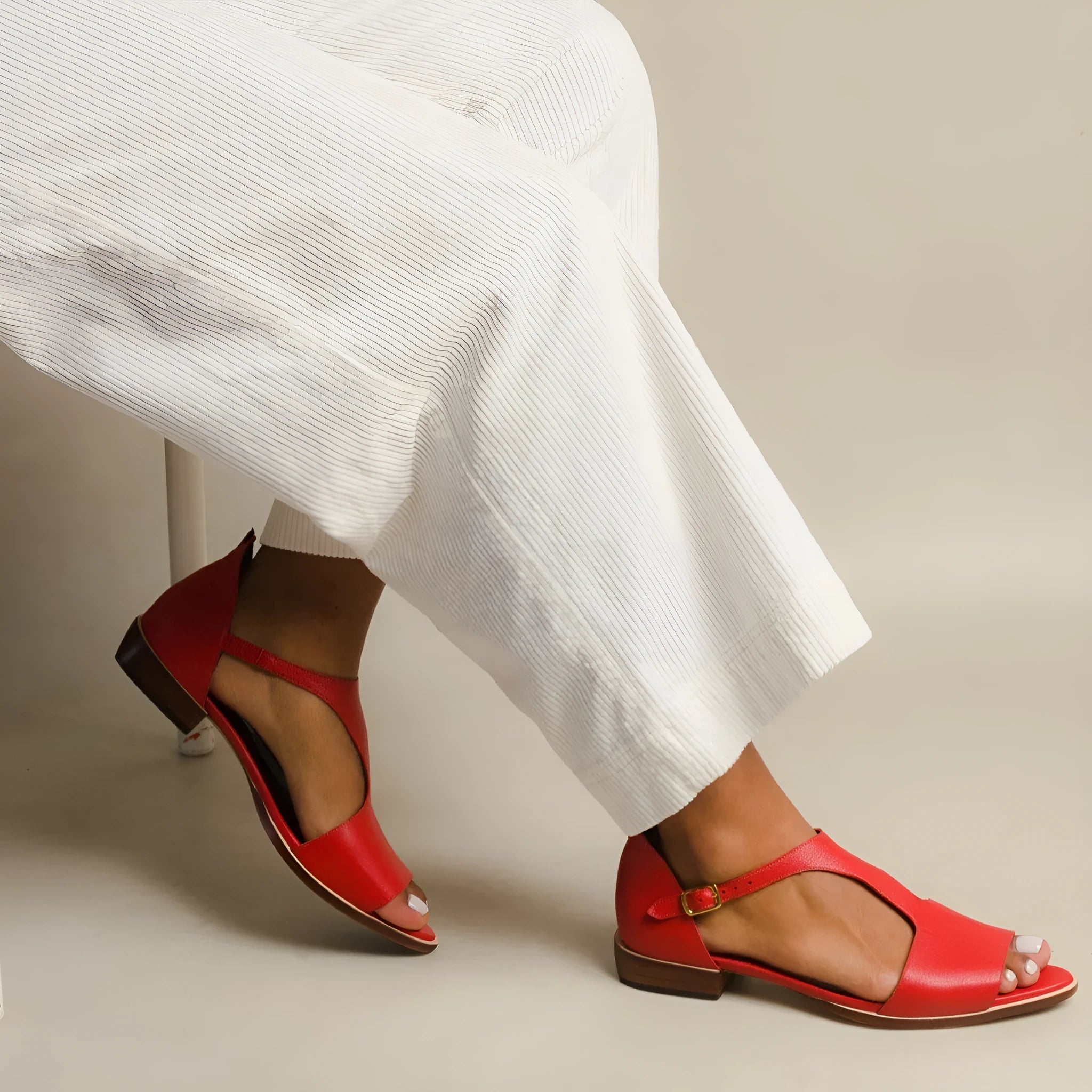Red women's plus size sandals with a square buckle and herringbone toe strap.