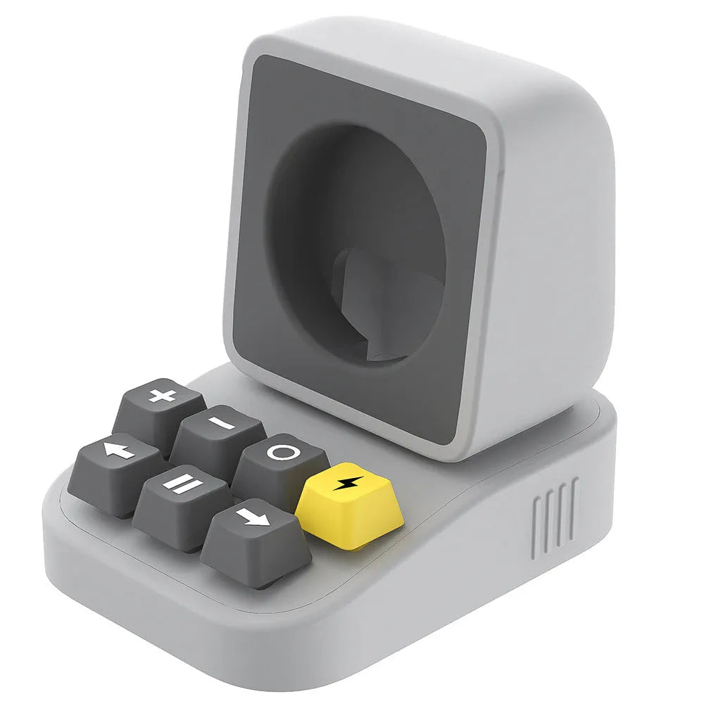 Silicone watch charger bracket in typewriter shape in grey, purple, and yellow colours on a desk