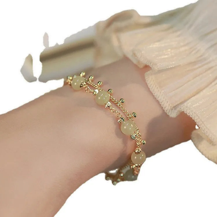 Hetian Jade bracelet with princess running beaded style on neutral background