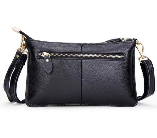 Lady's cowhide leather slant bag in apricot colour with hand strap and shoulder strap showing zipper compartments
