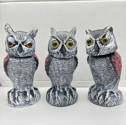 Artificial owl bird deterrent ornament with shaking head design in outdoor garden setting