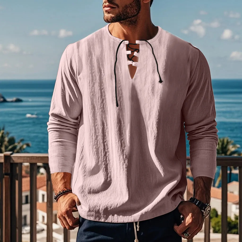 Man wearing a loose fit solid colour cotton linen beach shirt in a casual setting.