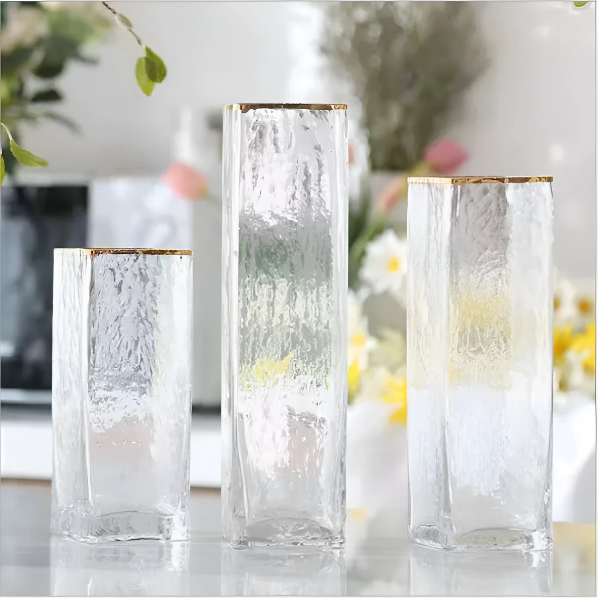 Transparent gold-painted glass vase on table with flower stems, 8x30cm size