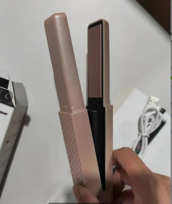 Pink and green mini cordless USB hair straightener with ceramic plates open on a white background.