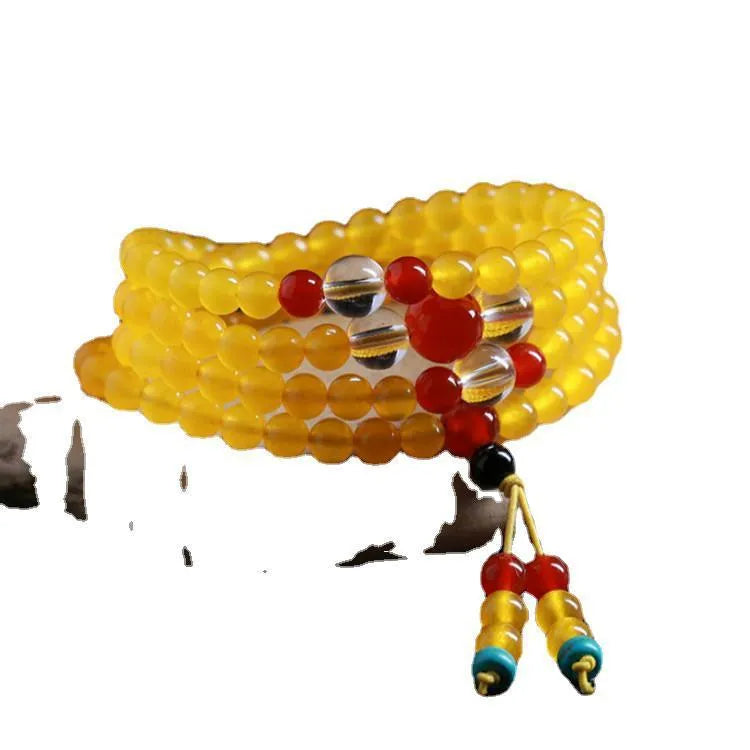 Women's geometric crystal necklace with lucky cat charm alongside 108 agate and canary stone beads
