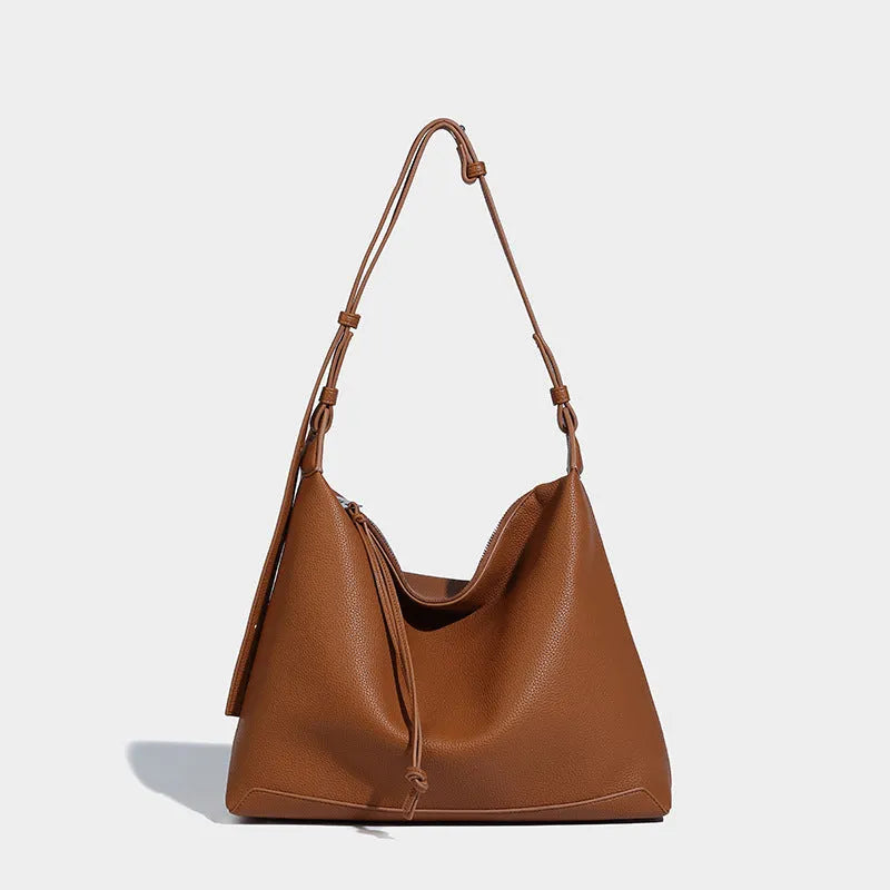 Soft PU leather messenger bag in caramel colour showing large capacity and shoulder strap.