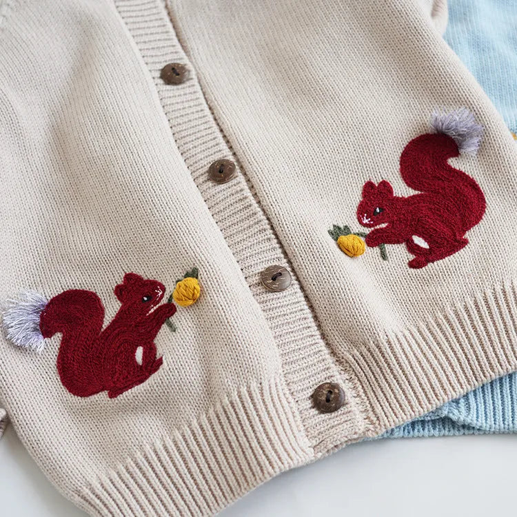 Kids cotton knit sweater with squirrel embroidery in beige colour on white background