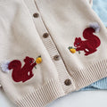 Kids cotton knit sweater with squirrel embroidery in beige colour on white background
