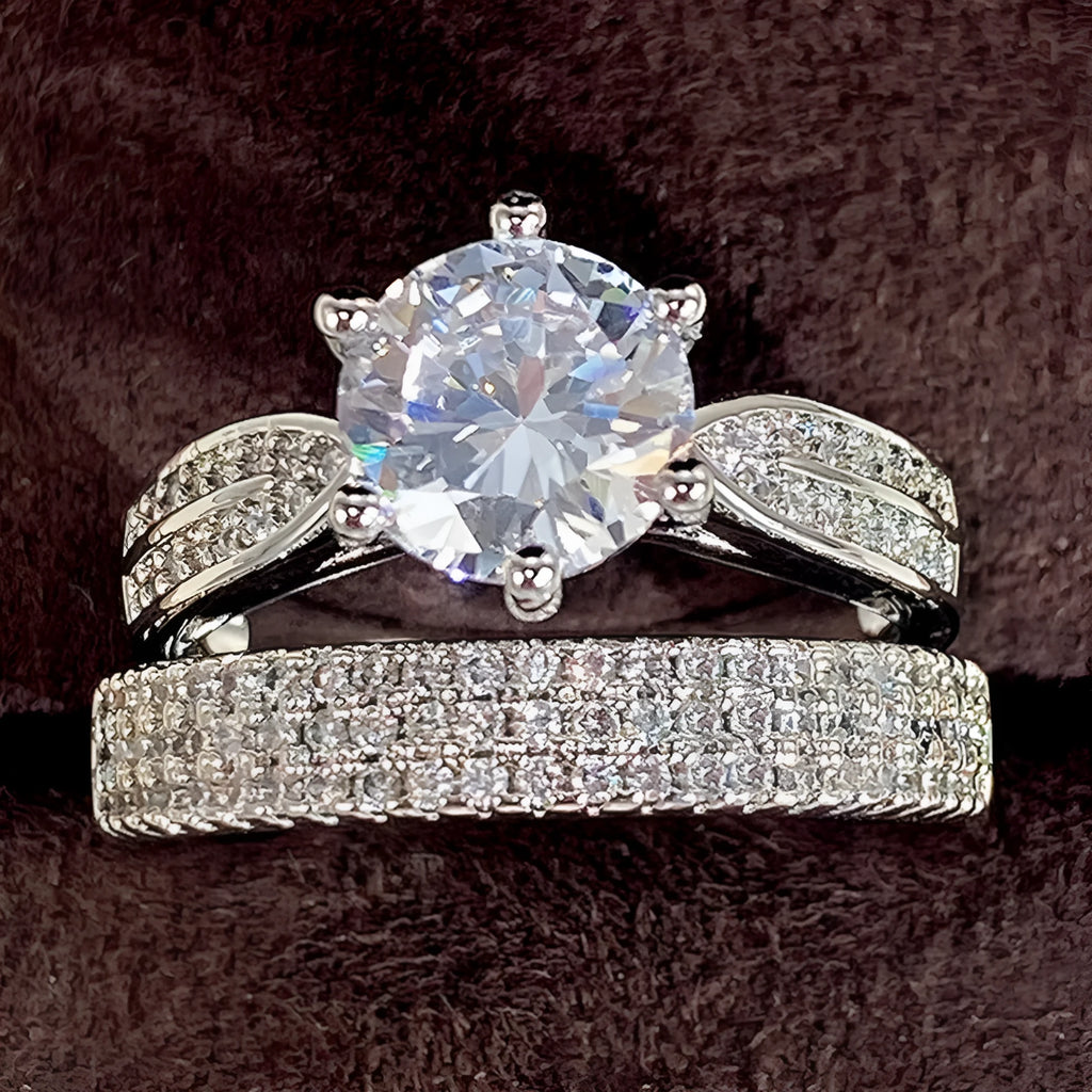 Geometric white gold colour alloy wedding ring bracelet with round detail on a finger.