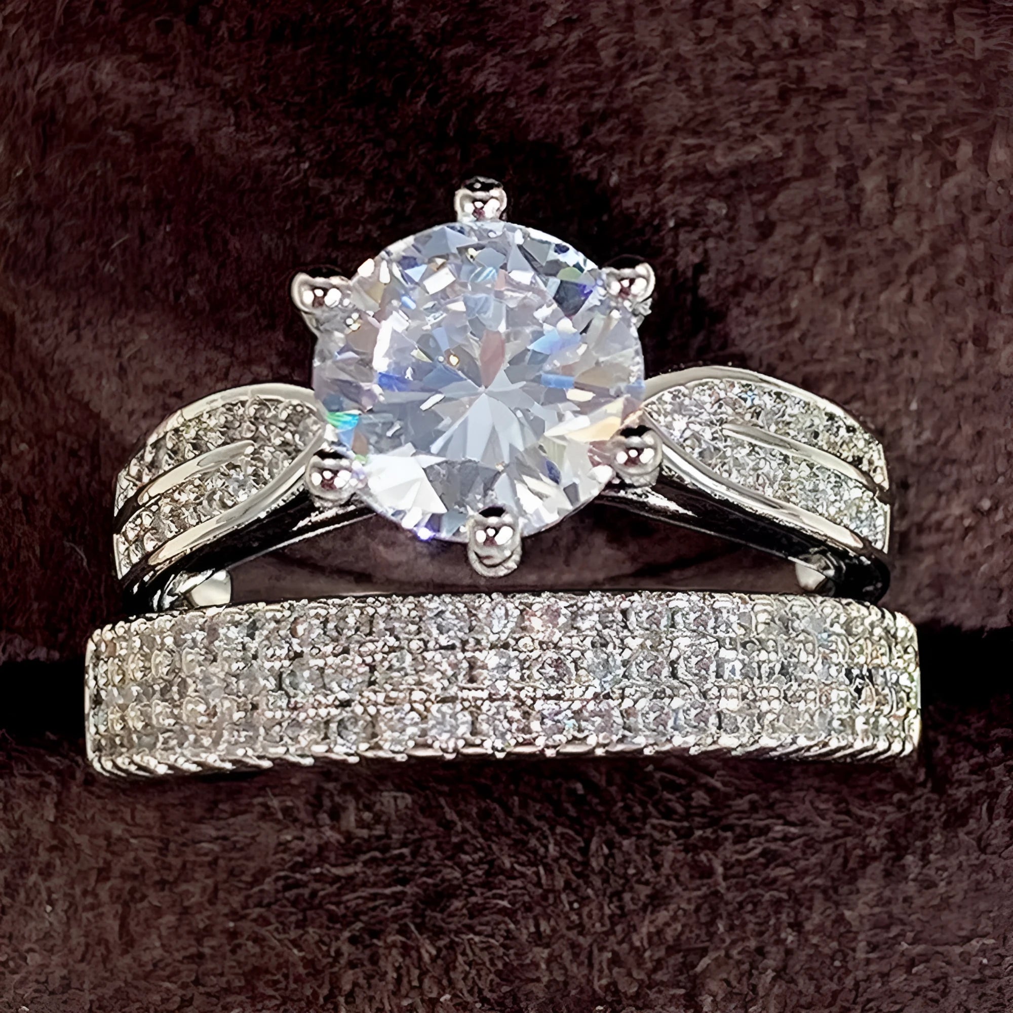 Geometric white gold colour alloy wedding ring bracelet with round detail on a finger.