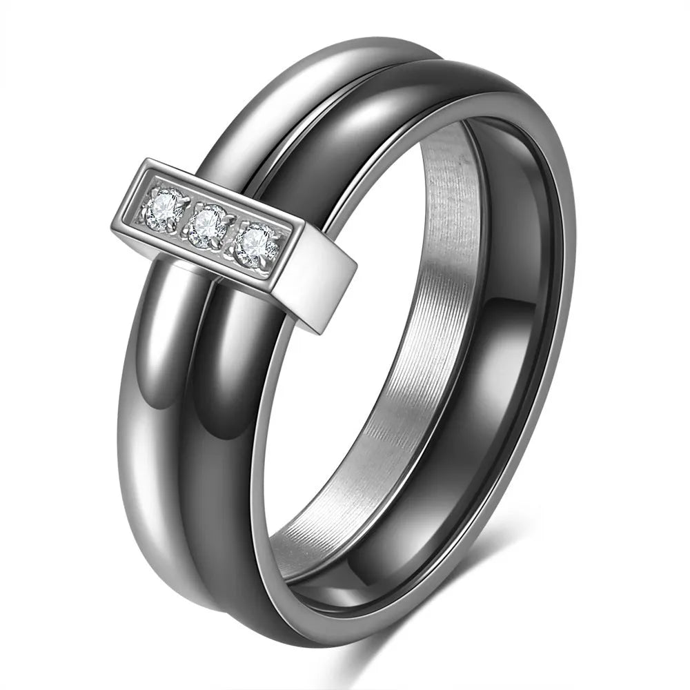 Glossy black ceramic women's ring with silver stitch-inlaid zirconium detail on a geometric band.
