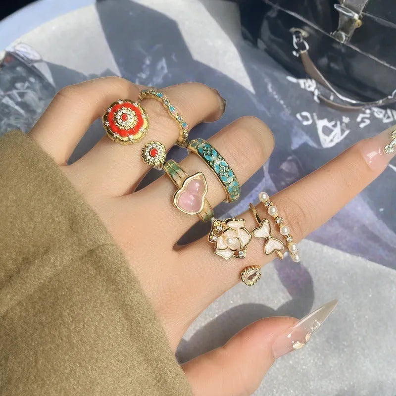 Adjustable copper ring with vintage gourd, flower, and bow design, inlaid with zircon stones.