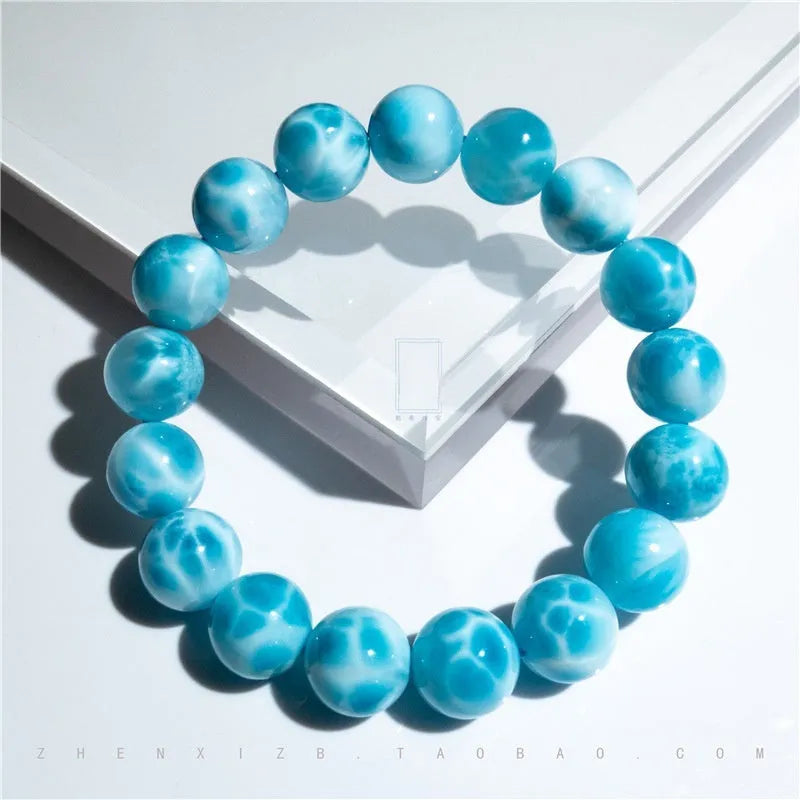 Blue Bodhi bracelet with natural sea-pattern crystal stones and pearl details in Maillard style.