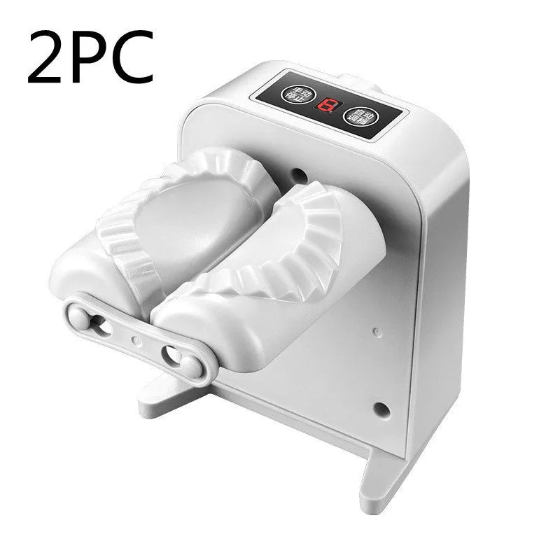 White automatic electric dumpling maker machine with charging cable, brush, and spoon.