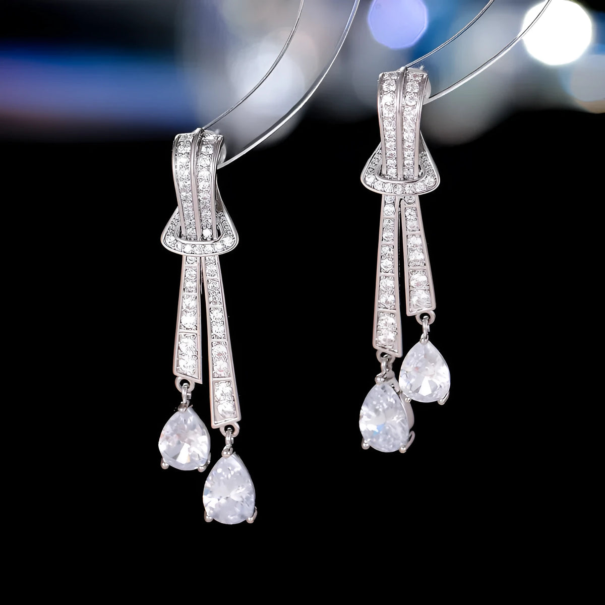 Knot drop earrings with silver needle post and zircon inlay in copper with electroplated finish, gold pearl colour