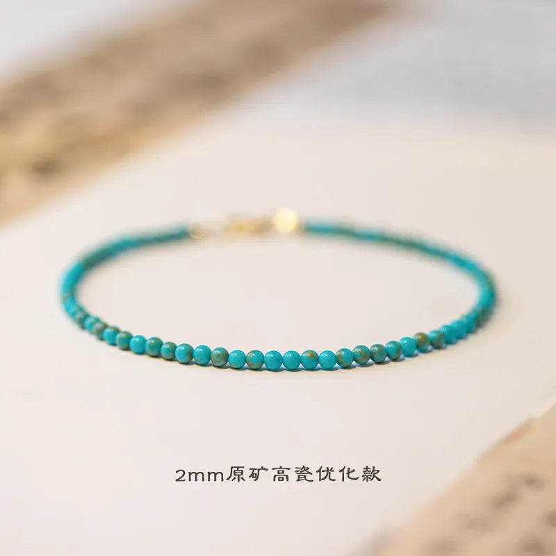 Close-up of a geometric bracelet made from small 2mm turquoise beads, shown in both raw and polished finishes, with a sizing chart for 14cm, 15cm, and 16cm wrists.