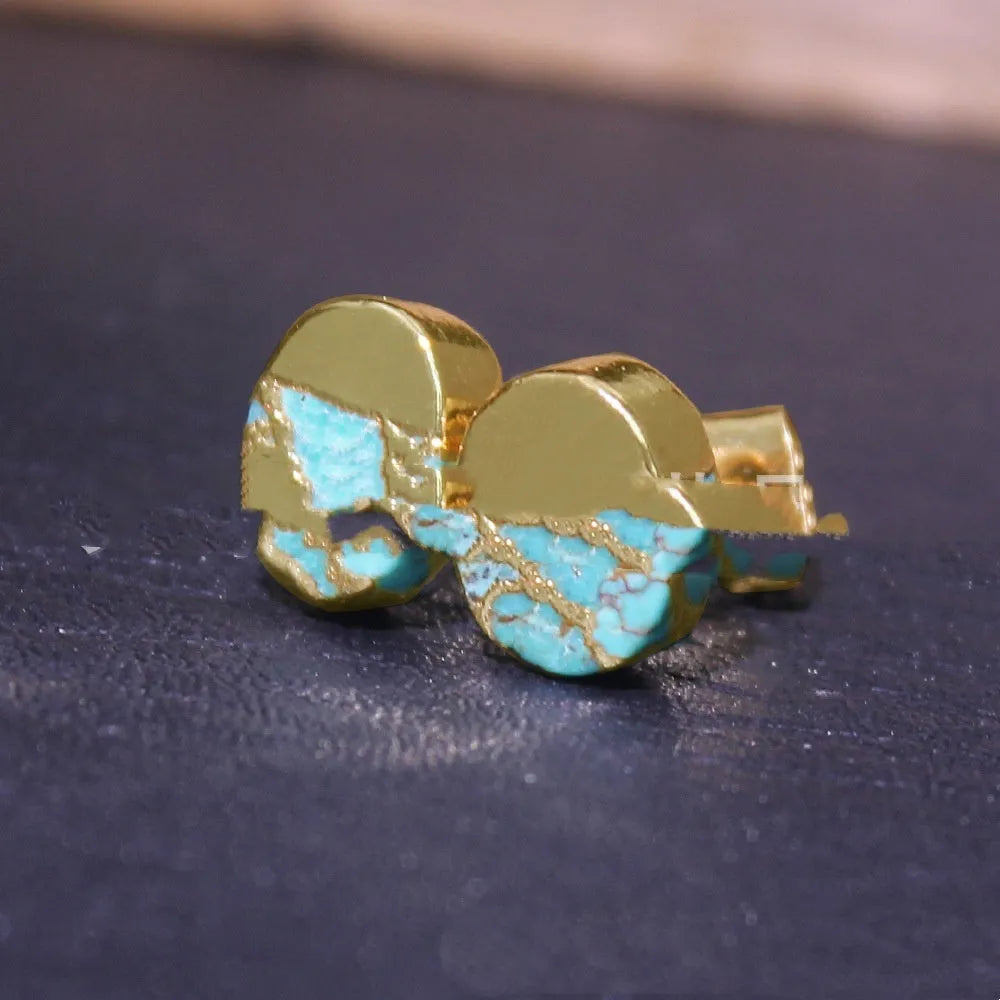 Close-up of handcrafted bohemian stud earrings with an irregular natural stone in colour ER1031 on a simple metal setting.