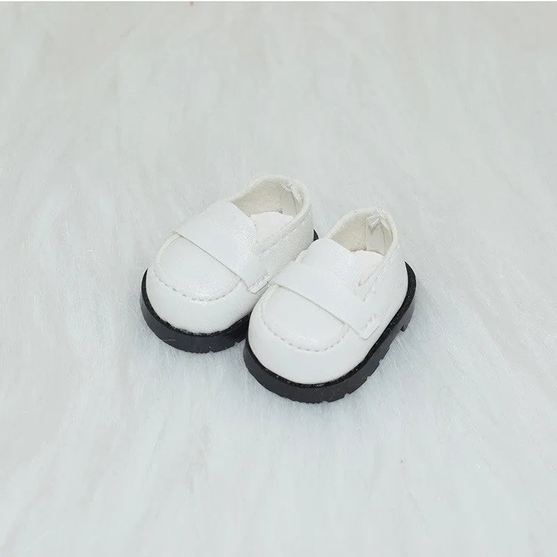 A pair of 17cm scale PU doll shoes in a selected colour and style, such as black leather shoes or brown boots.