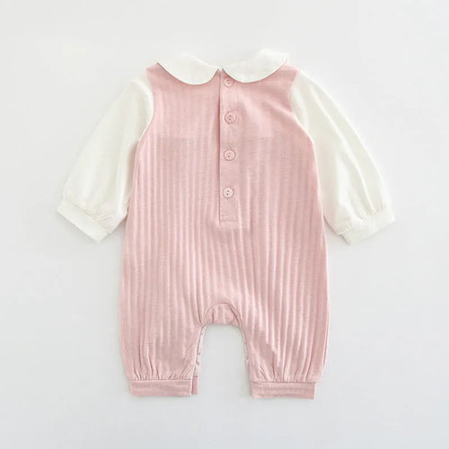Pink long sleeve cotton baby jumpsuit with single-breasted front closure for a girl.