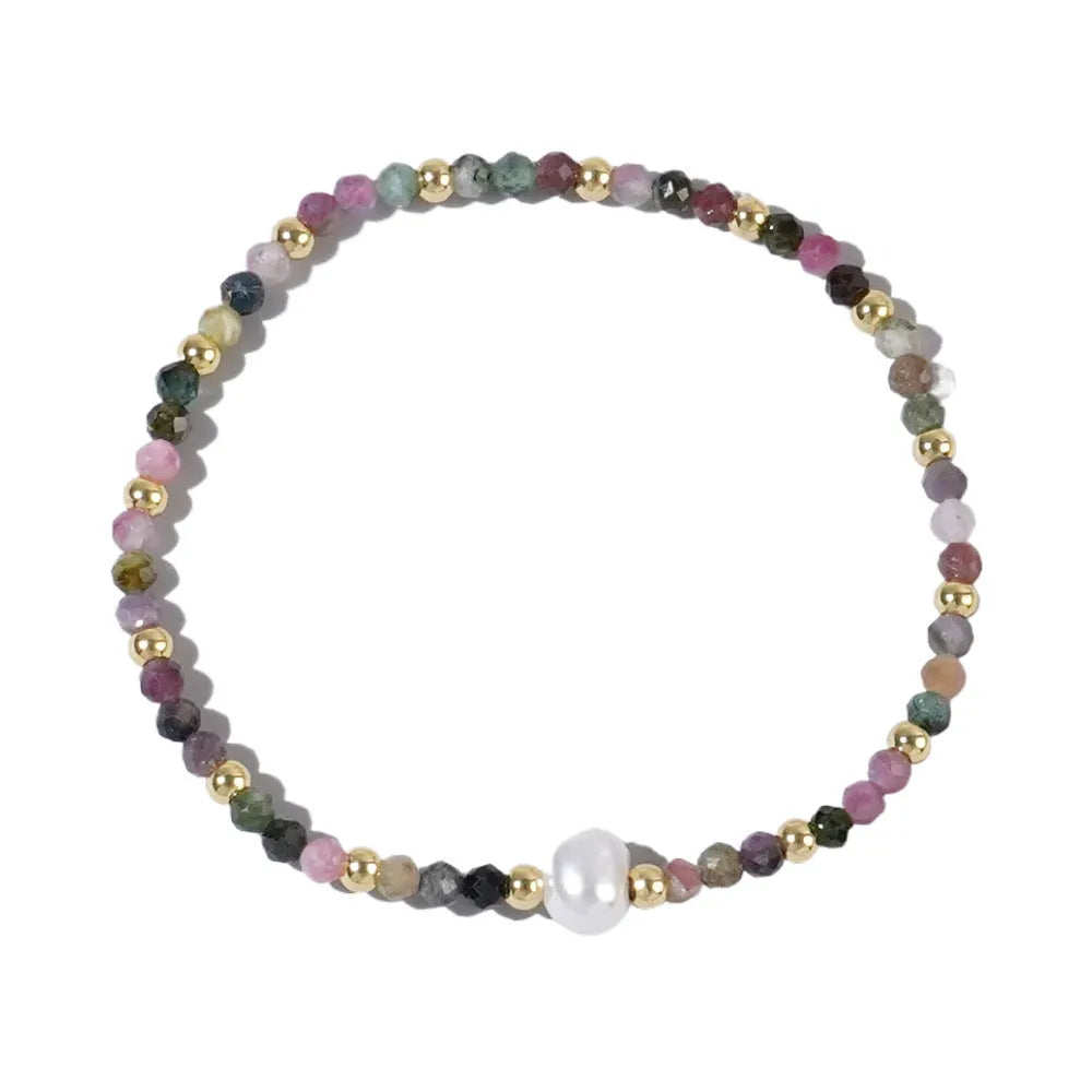 Close-up of a unisex natural stone bracelet with geometric ellipse beads on a wrist.