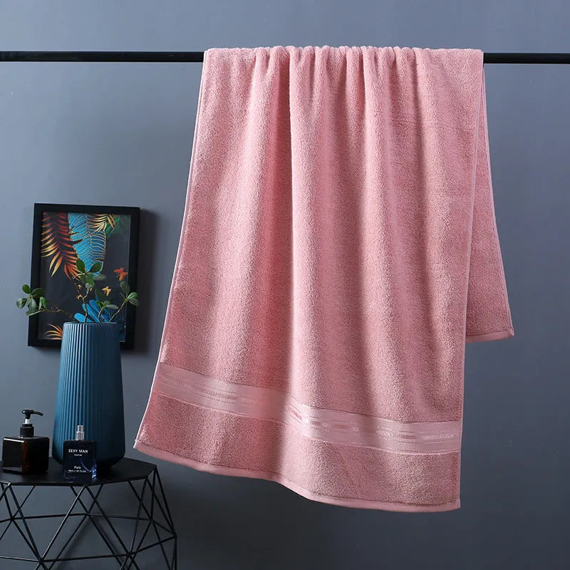 Three-piece cotton bath towel set in floral colours showing bath towel, hand towel and face cloth with optional logo printing