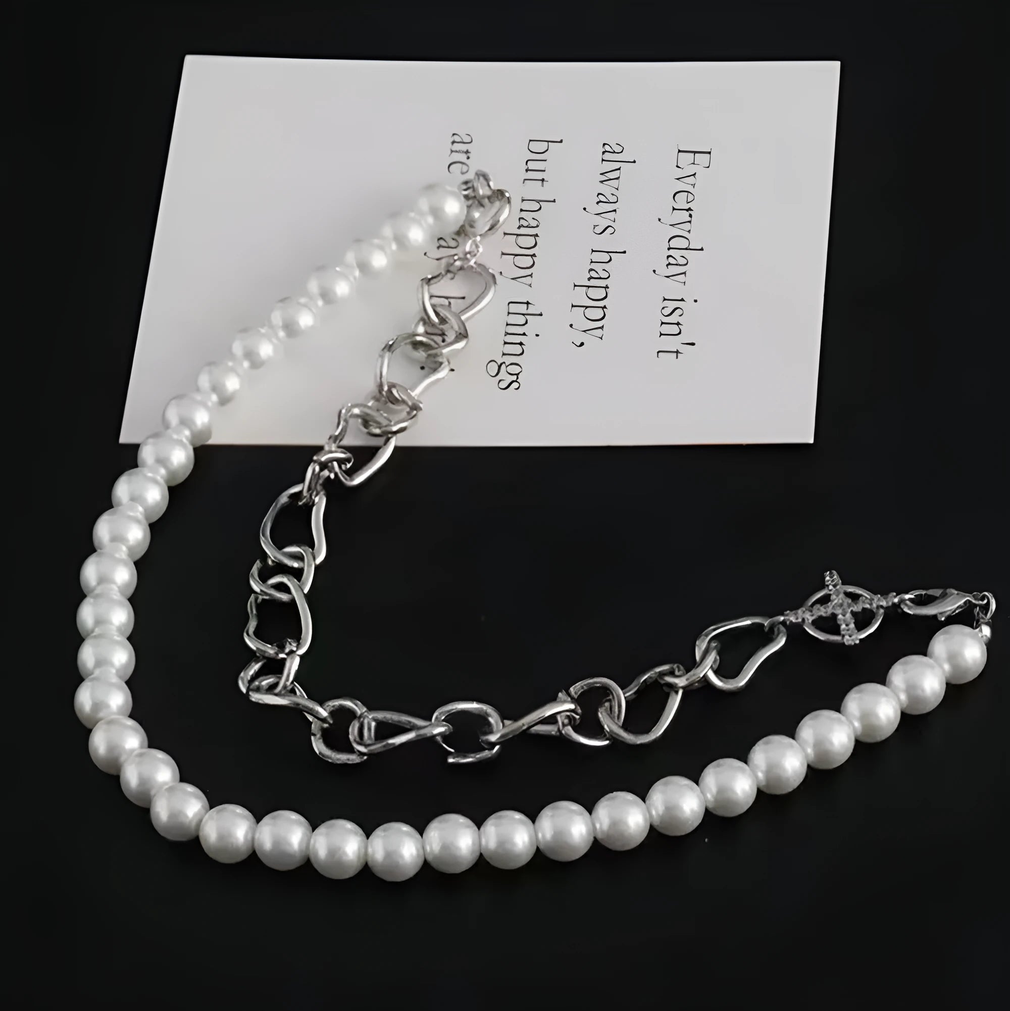 White acrylic geometric asymmetric pendant on a twisted chain, a clavicle-length necklace.