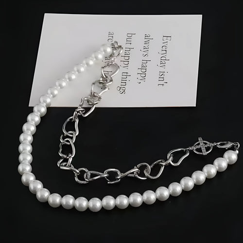 White acrylic geometric asymmetric pendant on a twisted chain, a clavicle-length necklace.