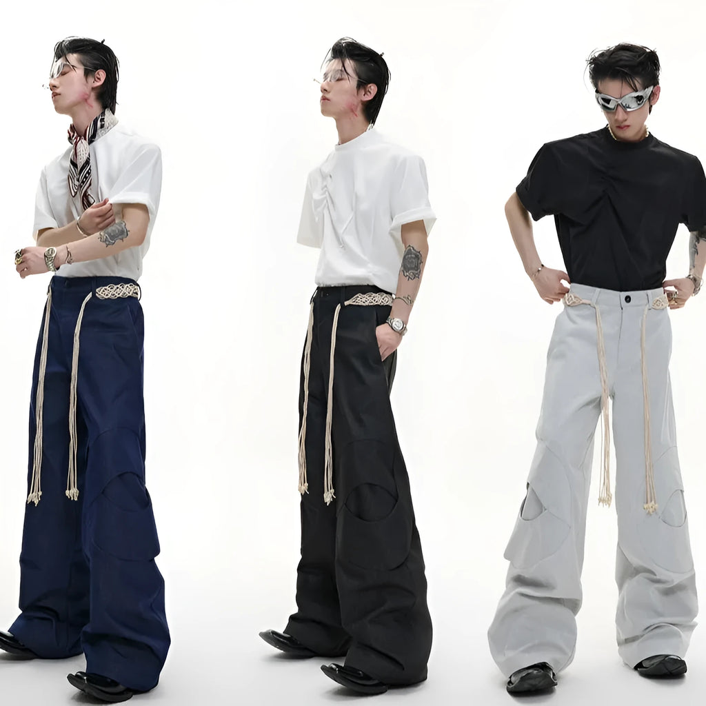 Man wearing dark blue loose-fit straight-leg cotton jeans with zip decoration and belt stitching.