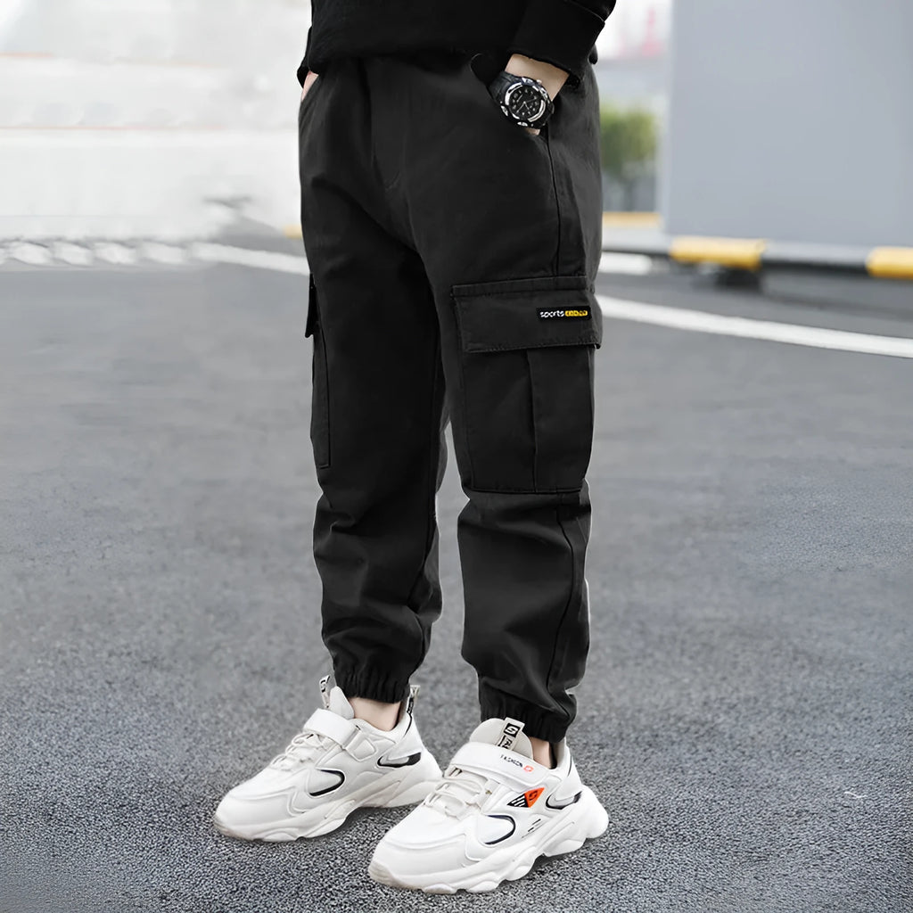 Boys' casual cotton summer trousers in army green, shown flat with size label visible.