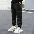 Boys' casual cotton summer trousers in army green, shown flat with size label visible.