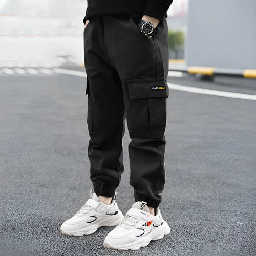 Boys' casual cotton summer trousers in army green, shown flat with size label visible.