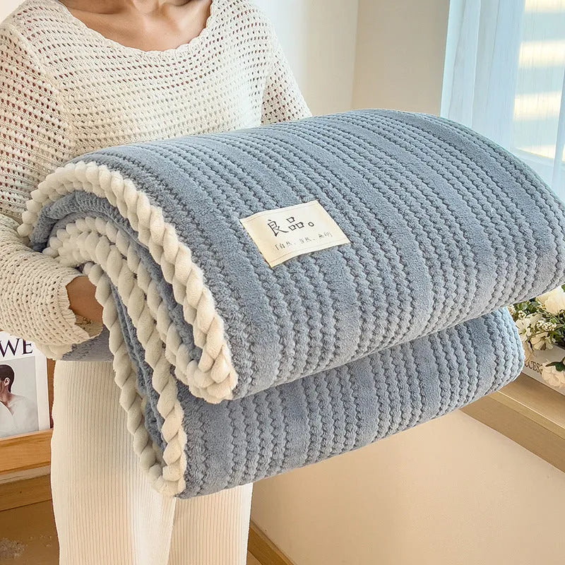 Solid colour jacquard milk velvet blanket in green on a bed with Nordic style decor