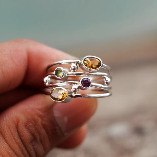 Silver bohemian diamond studded hollow copper ring with geometric ellipse shape on plain background