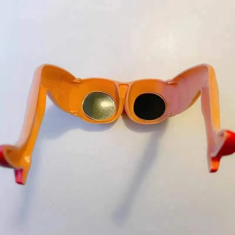 Orange plastic novelty sunglasses with leg hip style arms and a large wide frame.