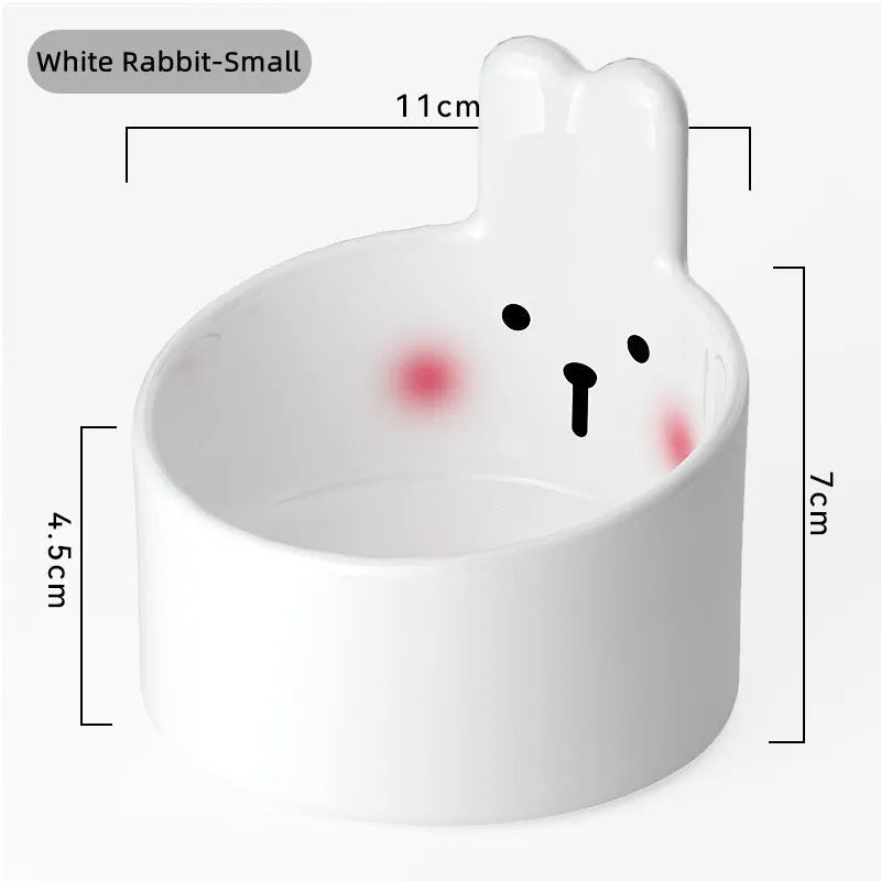 White and yellow ceramic pet bowls with raised neck guards in two sizes.
