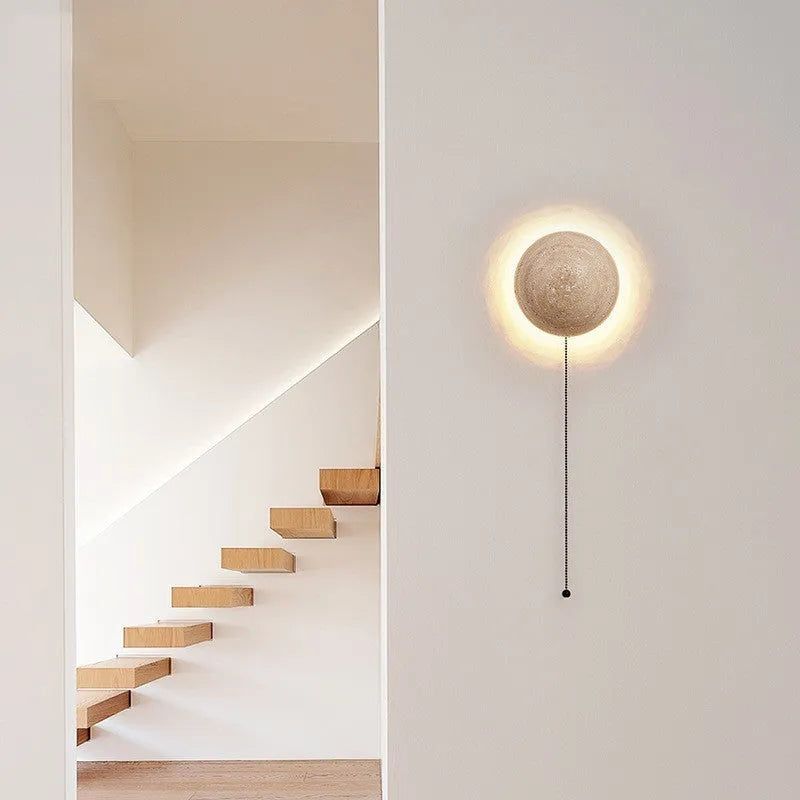 Yellow semicircle cave stone wall lamp with wooden fixture mounted on a wall.
