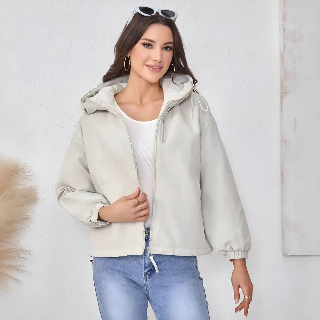 Women's grey loose-fit hooded polyester shell jacket with long sleeves.