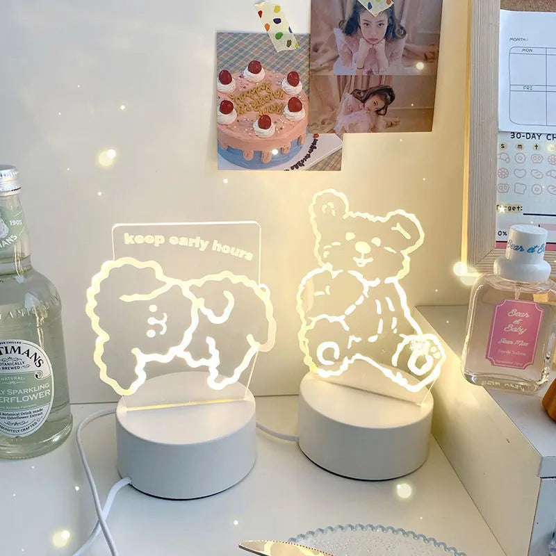 Teddy bear cartoon LED night light with acrylic shade on a table, USB cable attached