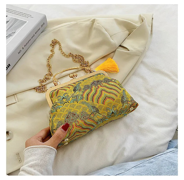Chinese embroidery cheongsam handbag in polyester with shell shape and internal zipper compartment