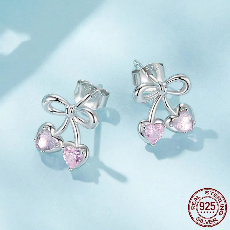 Sweet cherry stud earrings in 925 sterling silver with heart silhouette on light background