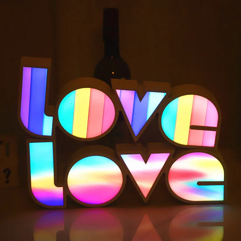 Rainbow style LED LOVE decorative table lamp with plastic shade on a table
