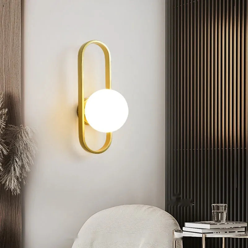 Minimalist glass wall lamp with iron body in black finish mounted beside bed
