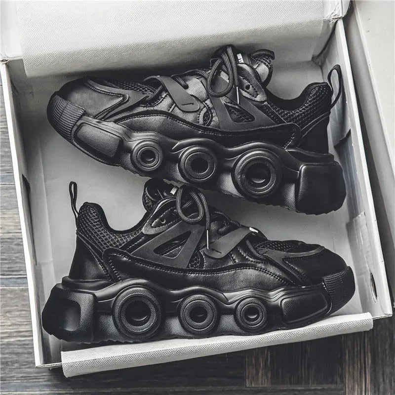 Men's black mesh sneakers with thick rubber sole, round toe, lace-up front, and abstract pattern