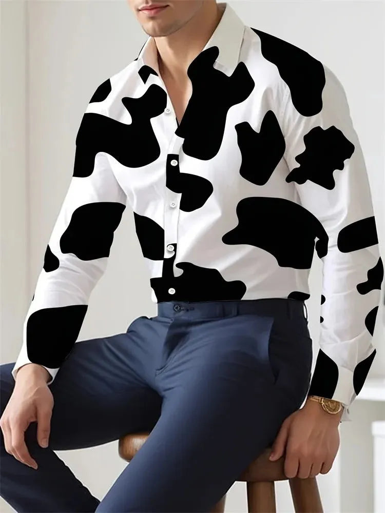 Man wearing a loose-fitting floral print Hawaiian shirt with long sleeves.